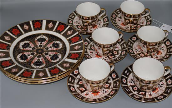 Four Royal Crown Derby plates and six cups and saucers